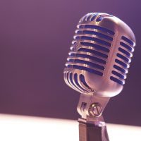 a silver microphone on a blurred background